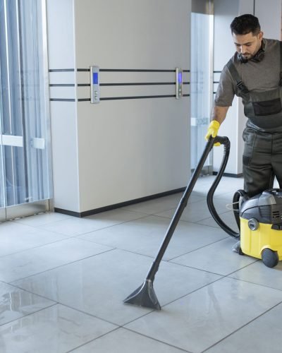 full-shot-man-vacuuming-office-floor